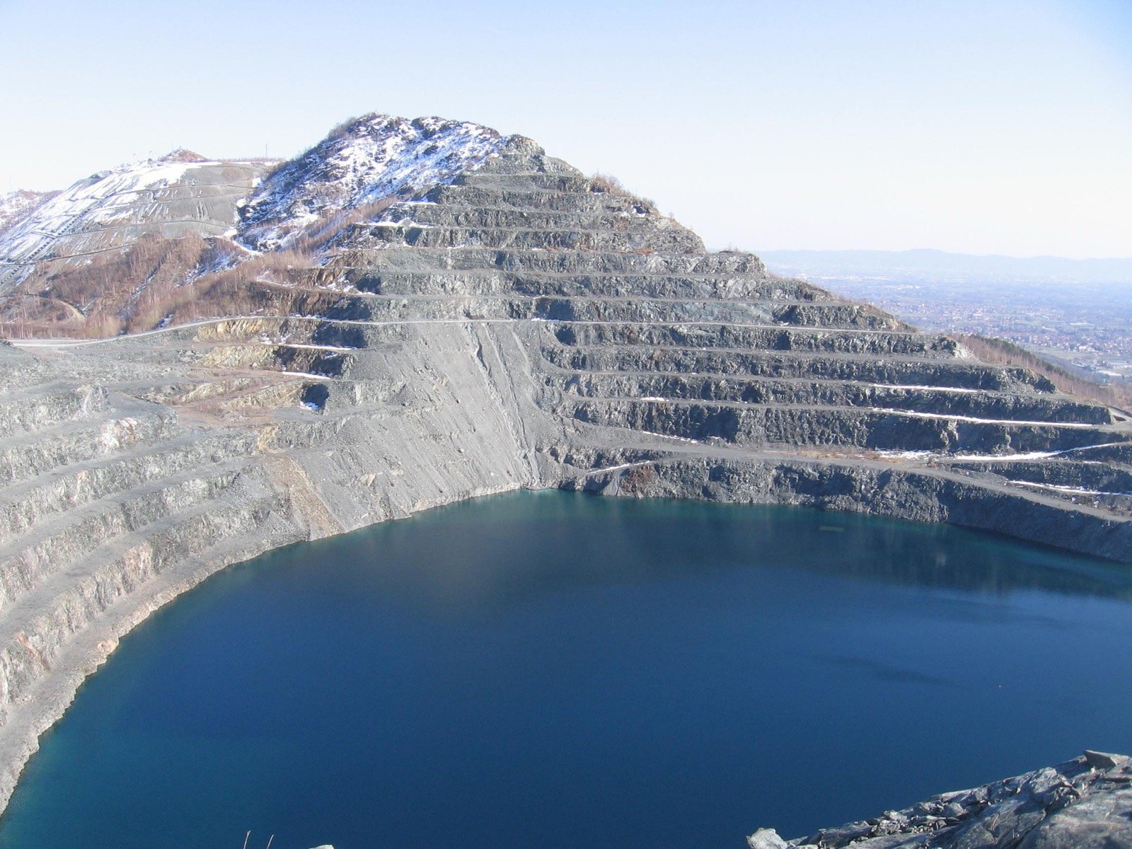 Terraced open-pit workings with a flooded lower bench